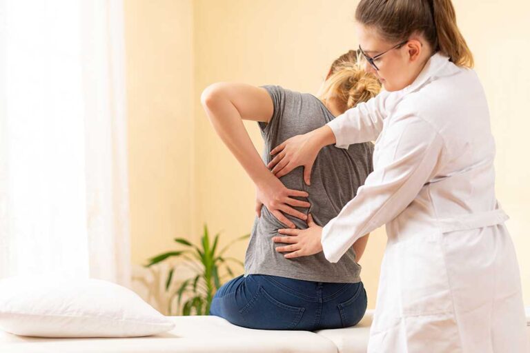 Person rolls to the side and pushes up from bed while managing morning back pain.